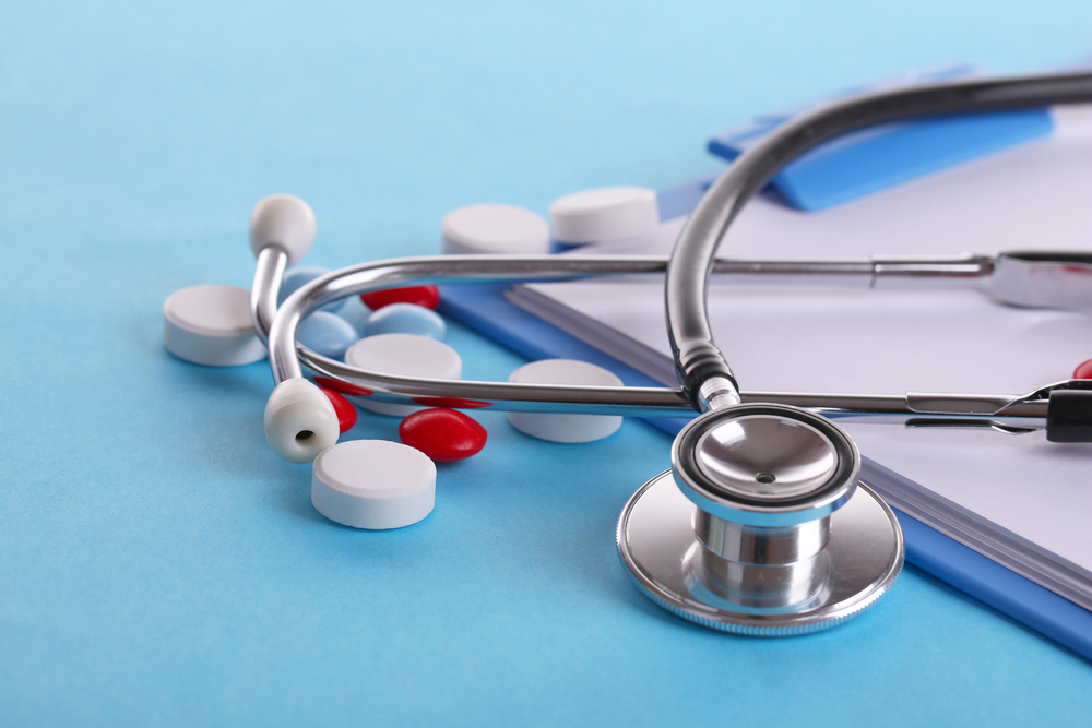 Stethoscope on a clipboard with medicine.