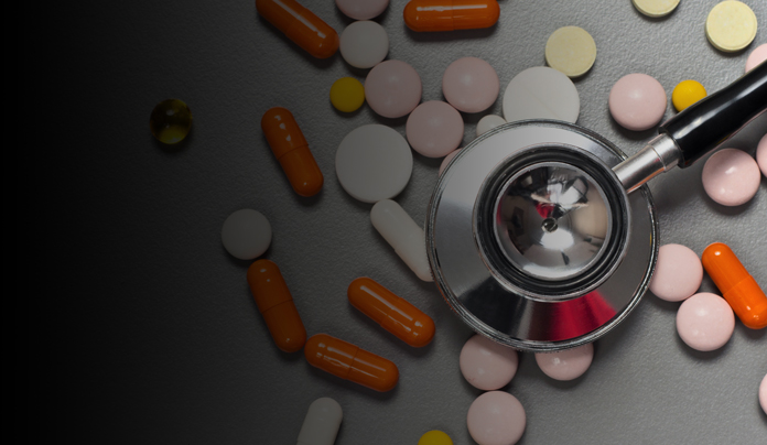 prescription pills scattered around a stethescope